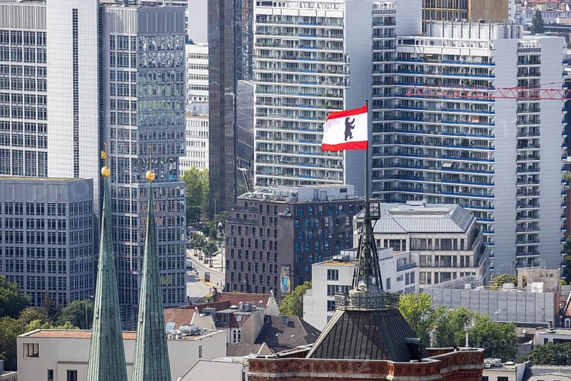 City view. View of the spires of the Rotes Rathaus and the Nikolaikirche. Flag with Berlin bear, the emblem and coat of arms of the federal capital Berlin, Germany, Europe