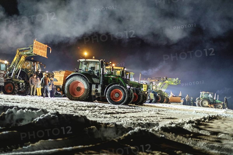 Tractors during a rally as part of the farmers' protests on the snow-covered Kirchbichl, Schliersee, Upper Bavaria, Bavaria, Germany, Europe