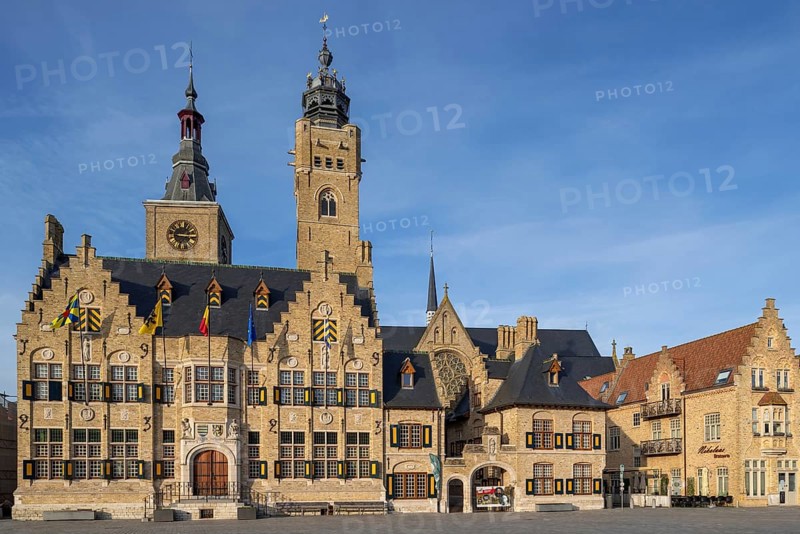 Market square showing town hall with belfy and St Nicholas Church tower, rebuilt after WWI in the city Diksmuide, Dixmude, West Flanders, Belgium, Europe