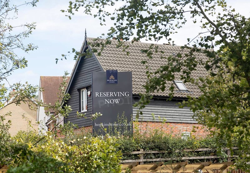 New houses modern property development, Hopkins Homes 'Reserving Now' sign, Saxmundham, Suffolk, England, UK