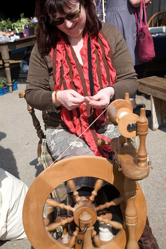 Woman demonstrating traditional spinning at a country craft event, Shottisham, Suffolk, England, United Kingdom, Europe