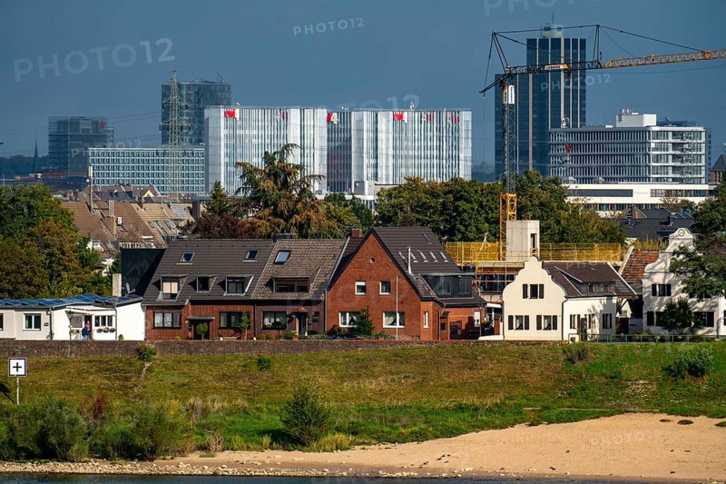 The skyline of Düsseldorf, with the RWI skyscrapers and office buildings on Friedrichstrasse, Ivorne residential buildings on the Rhine in the Hamm district, cargo ship on the Rhine, Düsseldorf, North Rhine-Westphalia, Germany, Europe