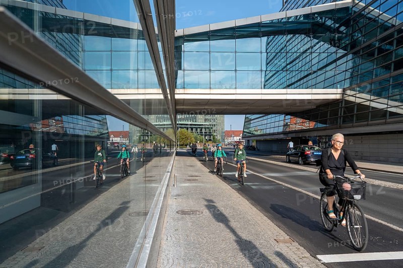 Cyclists on the cycle path on Christians Brygge Street, at the Black Diamond, Danish Royal Library, Copenhagen is considered the cycling capital of the world, 45 % of the population travel by bike, Denmark, Europe