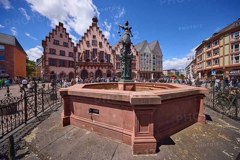 Fountain of Justice and Römer Town Hall on the Römerberg under a blue sky with cumulus clouds in Frankfurt am Main, Hesse, Germany, Europe