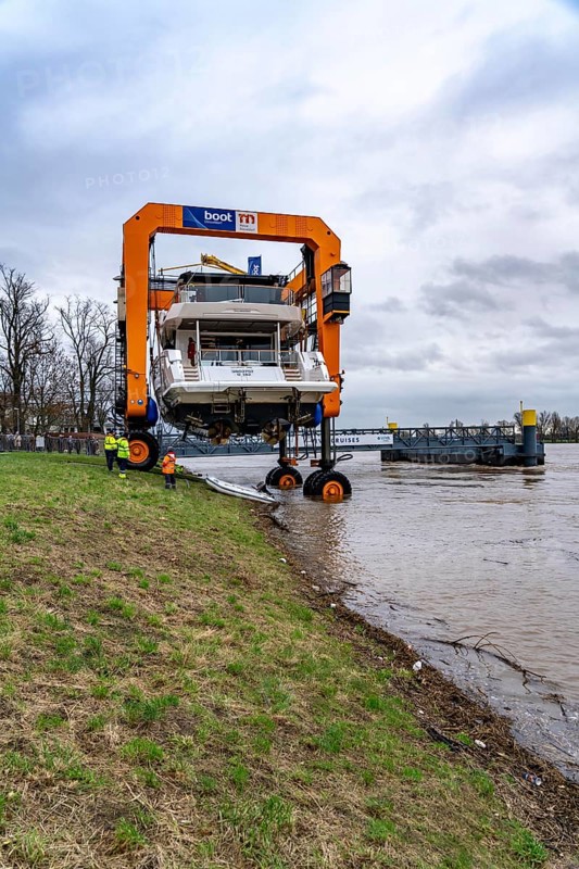 Craning the €6.3 million Sunseeker 88Y motor yacht, weighing 82 tonnes, in preparation for the world's largest water sports trade fair, Boot in Düsseldorf, luxury yachts are driven across the Rhine to the trade fair and brought ashore with the help of the Big Willi ship crane and transported to the exhibition halls on a low-loader, North Rhine-Westphalia, Germany, Europe