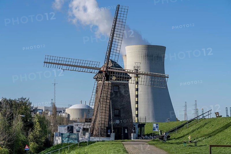 The Doel nuclear power plant on the Scheldt, one of two nuclear power plants in Belgium, consists of three operating units, each with a pressurised water reactor, as well as a decommissioned unit, historic Scheldemolen, windmill on the Scheldt dike, Antwerp, Belgium, Europe