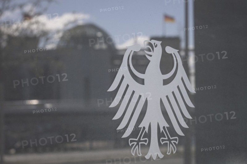 The federal eagle adorns the pane of the Federal Ministry of Education and Research, the Bundestag and Reichstag dome are visible in the reflection, in Berlin, 28 March 2024