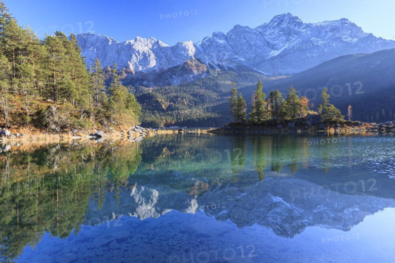 Steep mountains reflected in lake, evening light, autumn, Eibsee lake, Zugspitze, Bavaria, Germany, Europe