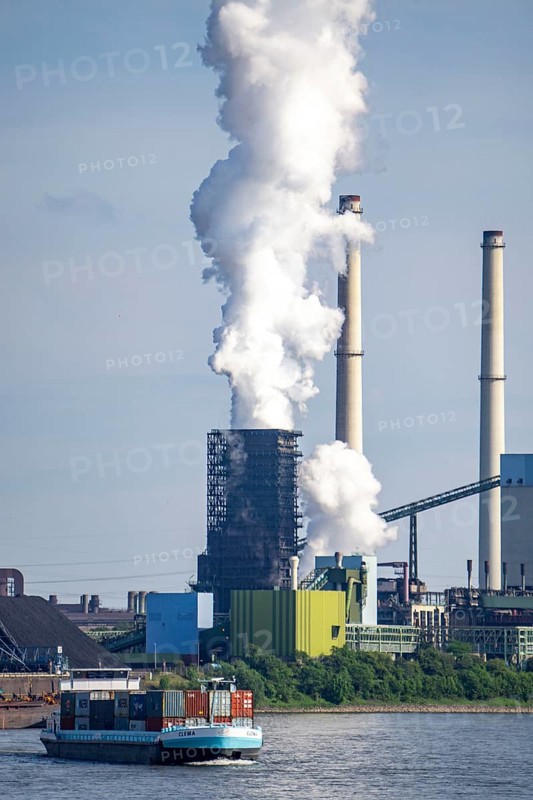 ThyssenKrupp steelworks in Duisburg-Marxloh, Schwelgern coking plant, chimney of the sintering plant, container cargo ship on the Rhine, Duisburg, North Rhine-Westphalia, Germany, Europe
