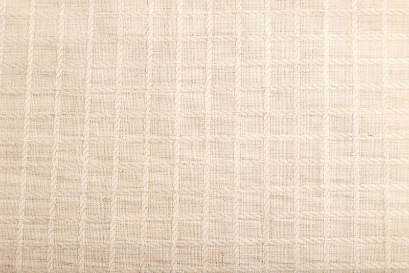 Fragment of smooth white linen tissue. Top view, flat lay, natural textile background and texture