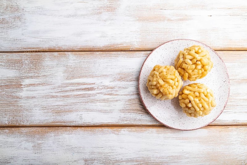 Traditional Tatar candy chak-chak made of dough and honey on a white wooden background. top view, flat lay, copy space