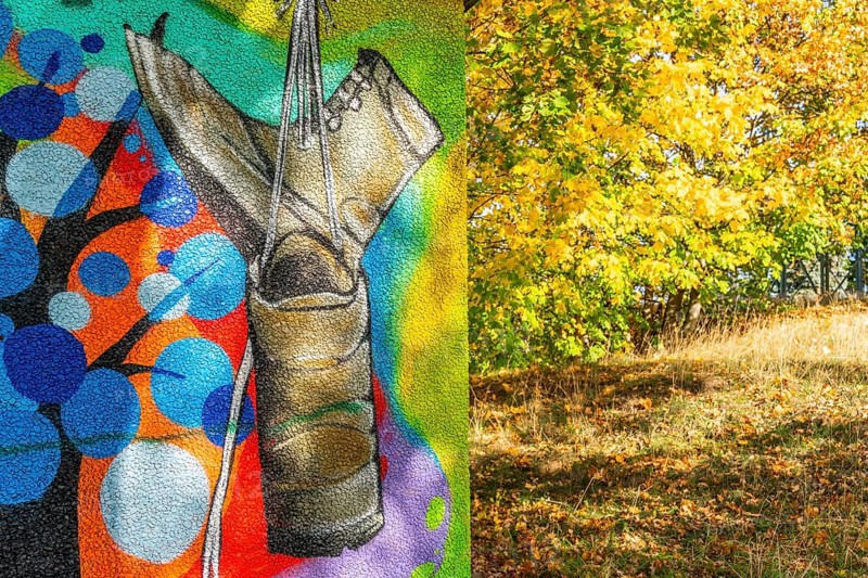 Graffito with hiking boots and trees with autumn foliage, Wiesenburg, International Art Trail, Hoher Fläming nature park Park, Brandenburg, Germany, Europe