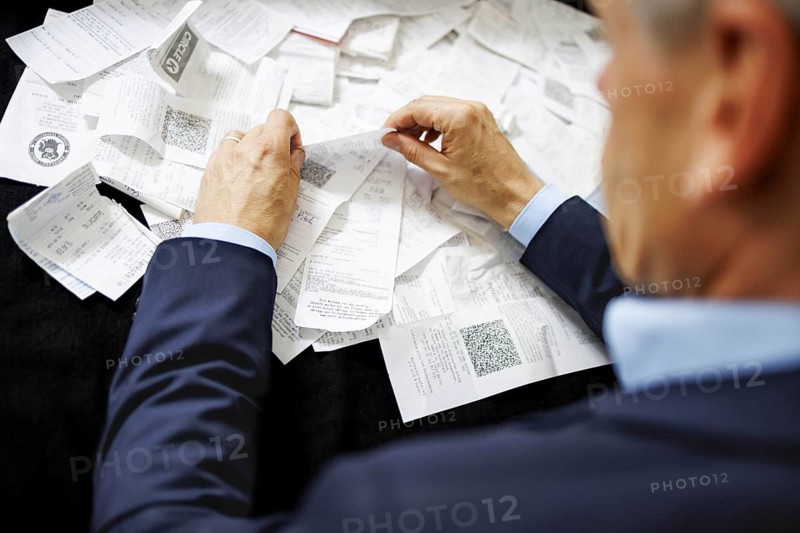 The subject of taxes. A man holds receipts in his hand in Berlin, 09/08/2024