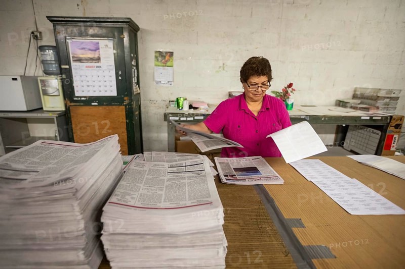 Liberal, Kansas, Maria Ruiz puts mailing labels on copies of the Kiowa County (Colorado) Independent. The Independent is one of many local newspapers from four states printed in the Liberal Leader & Times' printing plant. The Leader & Times hopes this will help keep local journalism alive. Across the country, more than 2, 000 local newspapers have closed in recent years