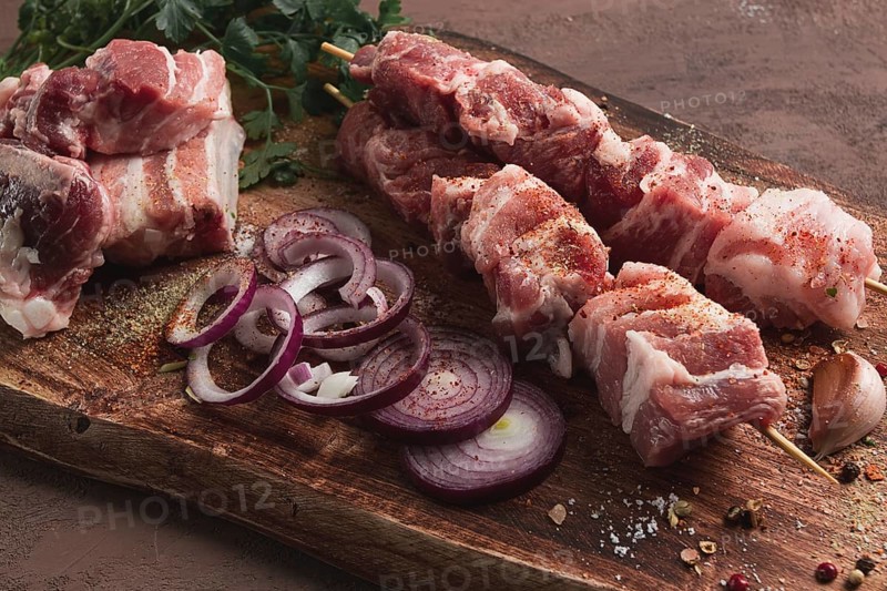 Raw pork meat, on wooden sticks, pickled kebab, with spices, top view, no people