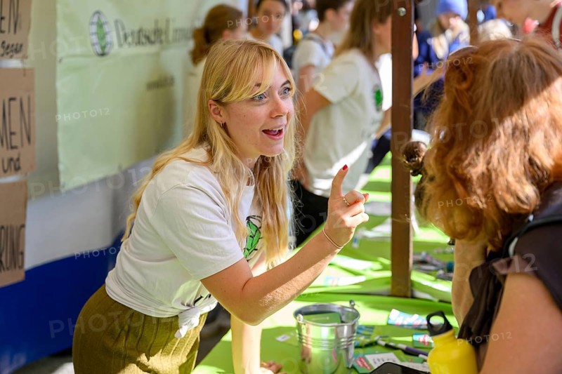 Employee at the Deutsche Umwelthilfe stand at the 14th Global Climate Strike of Fridays for Future, Chancellery, Berlin, 20/09/2024