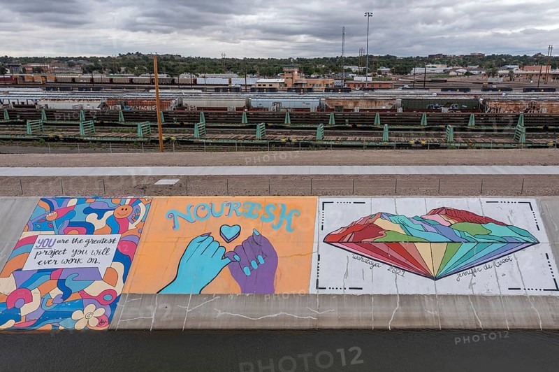 Pueblo, Colorado, Murals line a concrete levee for three miles along the Arkansas River. The levee was built after a disastrous 1921 flood. Students painted unauathorized murals in the 1970s, but the artwork has since become accepted as the Pueblo Levee Mural Project