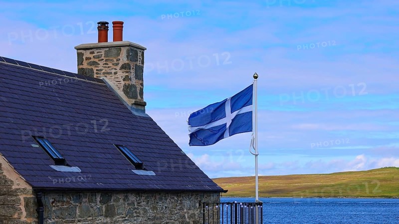 Shetland Flag waving on a typical medieval house in Lerwick downtown and port in Scotland, England, United Kingdom, Europe