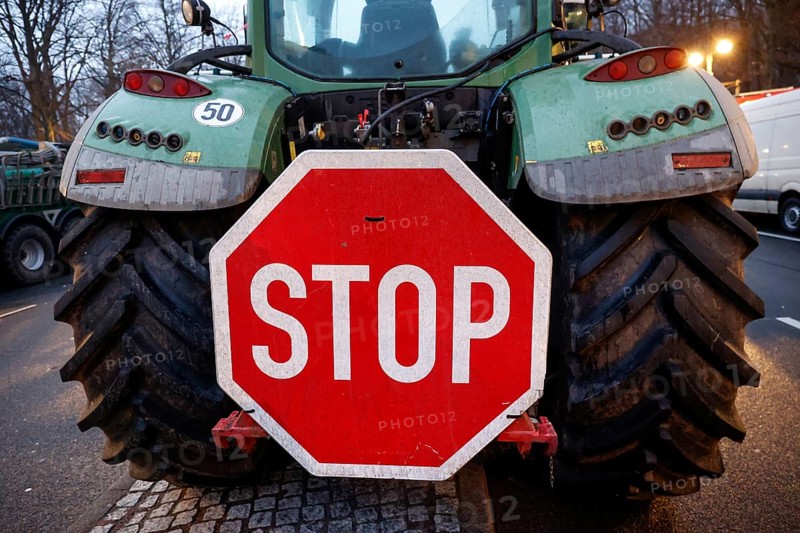 Large stop sign on a tractor. Thousands of farmers demonstrate with their tractors against the planned cancellation of the agricultural diesel subsidy, Berlin, 15.01.2024