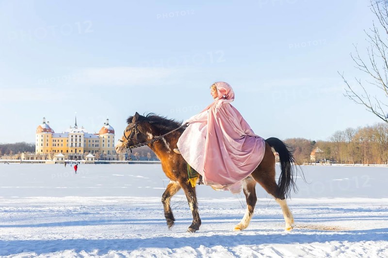 This year, the most popular fairytale film of all time is celebrating a special anniversary. At Moritzburg Castle, one of the film's locations, the exhibition on the cult film Three Hazelnuts for Cinderella is opening for the twelfth time - with an anniversary-worthy supporting programme and special exhibition. Model Tamara Kretschmer once again slipped into the coveted role of the legendary Cinderella with the ball gown. Here she rides the legendary film horse Catano, Moritzburg, Saxony, Germany, Europe
