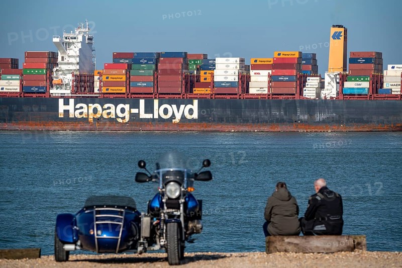 Container freighter Al Manamah, owned by Hapag-Lloyd, and VALPARAISO EXPRESS, leaving the harbour entrance of the deep-sea port Maasvlakte 2, the seaport of Rotterdam, Netherlands, on an artificial land area off the original coastline