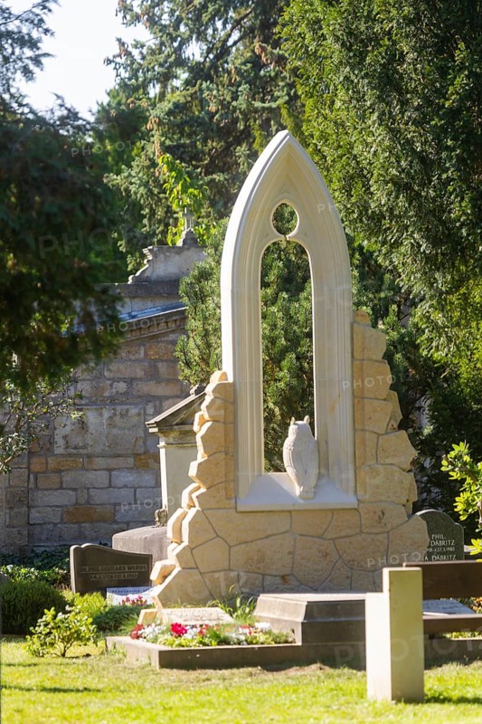 A new monument can be seen at Caspar David Friedrich's grave in Dresden's Trinitatisfriedhof cemetery to mark the 250th birthday of the most famous Romantic artist. The Gothic church window made of sandstone with an owl in rear view on the ledge. The construction was supported by the actor and Friedrich admirer Tom Pauls, Grave of Caspar David Friedrich, Dresden, Saxony, Germany, Europe