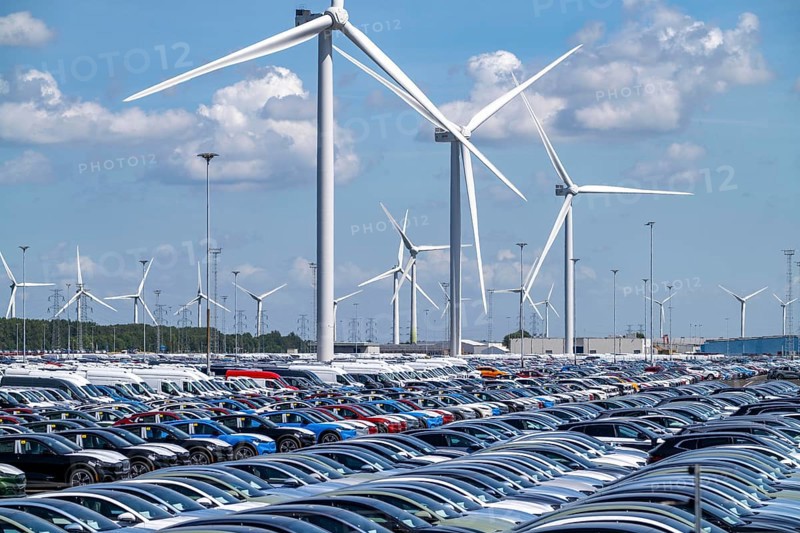 Storage area for new cars in the port of Vlissingen-Oost, vehicles are temporarily stored on over 100 hectares to ship them from Europe to the United Kingdom, Ford cars, others such as models from the Chinese car manufacturer BYD are delivered from here in Europe, wind farm, Netherlands