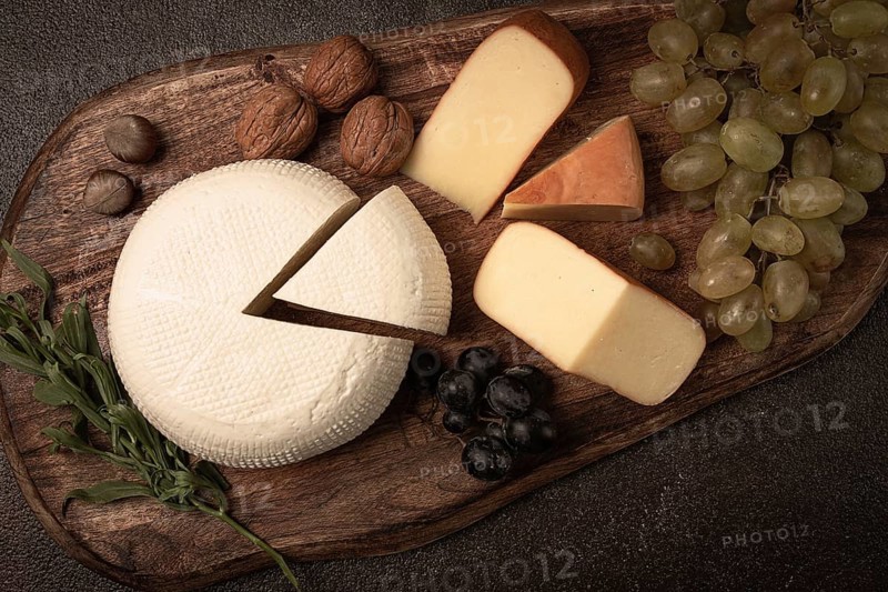 Georgian cheese, Imeretian and smoked suluguni, grapes, nuts, on a cutting board, Georgian cuisine, no people