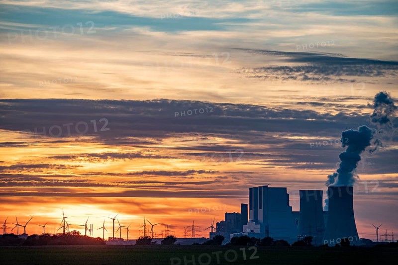 The RWE lignite-fired power plant Neurath, near Grevenbroich, largest German coal-fired power plant, second largest in Europe, Block F-G, wind farm, sunset, North Rhine-Westphalia, Germany, Europe