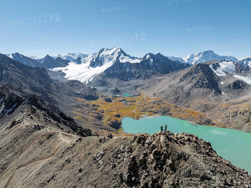 Hiker at the pass at 4000m, aerial view, mountains with glacier, mountain pass and mountain lake Ala-Kul Lake, Tien Shan, Kyrgyzstan, Asia