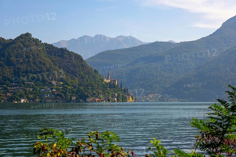 Church Santa Maria del Sasso with Trees Branches on the Mountain Side and Lake Lugano in Morcote, Ticino, Switzerland, Europe