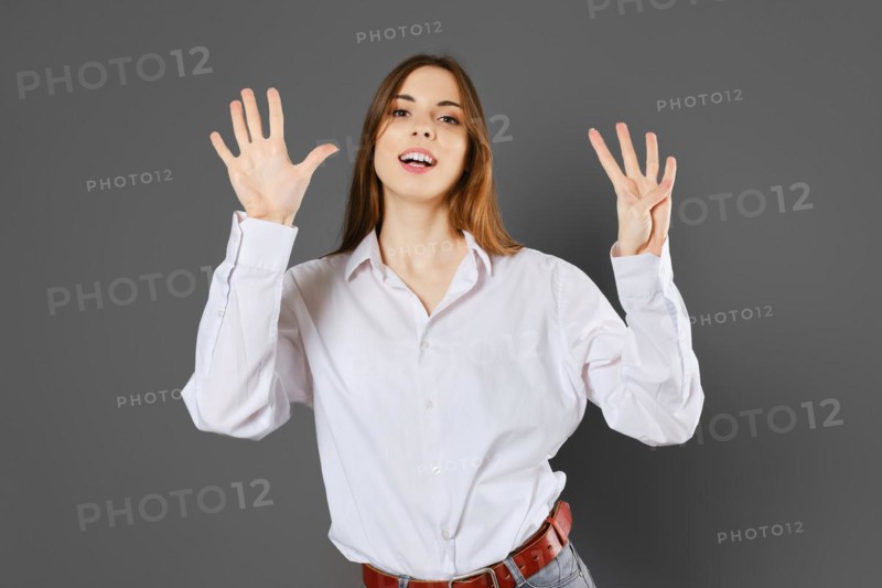 Inspired young woman shows nine fingers. Counting with fingers concept