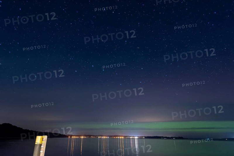 Northern lights (aurora borealis) shine on a starry night over Lake Plau, Ganzlin, Mecklenburg-Vorpommern, Germany, Europe