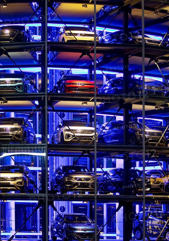 An illuminated car tower with new cars for delivery in the evening, detail, Autostadt, Volkswagen AG, Wolfsburg, Lower Saxony, Germany, Europe