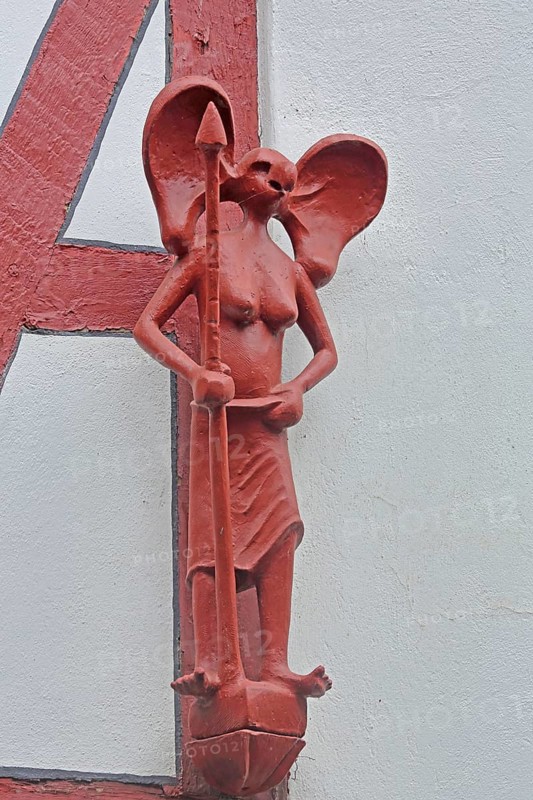 Red sculpture with spear at the Hensler bakery, female figure with large ears, modern art, arts and crafts, Kolpingstraße, Old Town, Limburg, Hesse, Germany, Europe