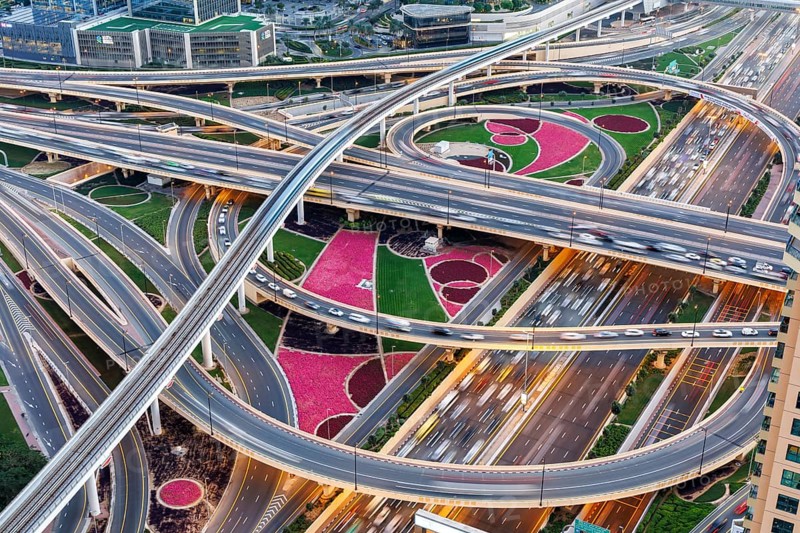 Intersection of Sheikh Zayed Road traffic on the road near the Burj Khalifa with Metro in Dubai, United Arab Emirates, Asia