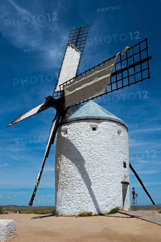 White windmill in a rural area with clear sky and few clouds, Consuegra, Toledo, Castilla-La Mancha, Route of Don Quixote, Spain, Europe