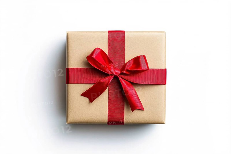 Top view of Christmas gift box wrapped in brown craft paper and red ribbon on white background. Generative Ai, AI generated