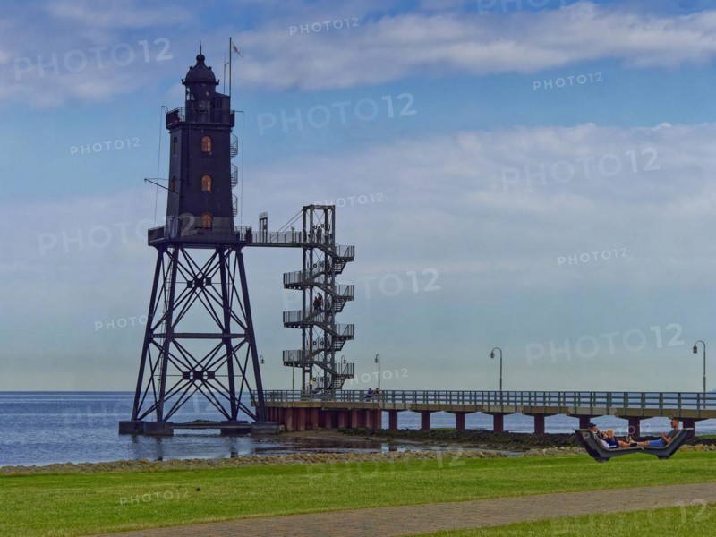 The Obereversand lighthouse, the former Eversand rear light, stands on the Wadden Sea in Dorum-Neufeld on the Wurster North Sea coast. Lower Saxony, Germany, Europe