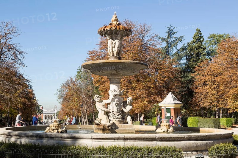 People walking by monument fountain in El Retiro park, Madrid, Spain, Europe