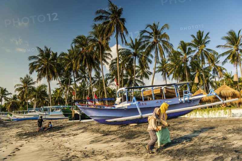 Muslim woman in the evening sun at Mangsit beach in Sengiggi, boat, fishing boat, palm beach, youth, Islam, religion, headscarf, travel, tourism, sea, ocean, island, coast, tropical, tropics, Asian, natural landscape, untouched, tourism, holiday, lonely, deserted, tranquillity, authentic, authenticity, original, atmosphere, holiday mood, long-distance travel, tradition, traditional, poverty, culture, tradition, holiday idyll, Lombok, Indonesia, Asia