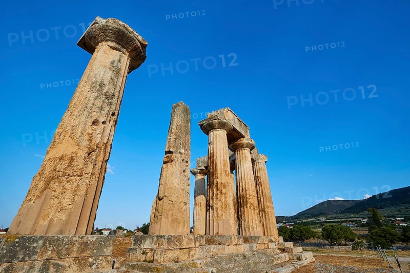 Archaic Temple of Apollo, Doric Columns, Historic columns against a picturesque backdrop of nature and mountains, Archaeological site, Archea Korinthos, Corinth, Peloponnese, Greece, Europe