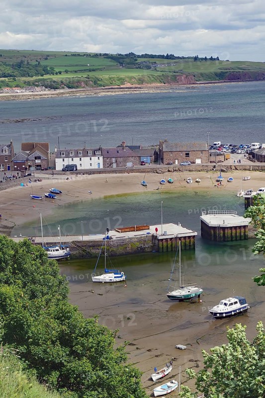 Coastal village with beach, boats and houses surrounded by green countryside, Stonehaven, Aberdeenshire, Scotland, United Kingdom, Europe