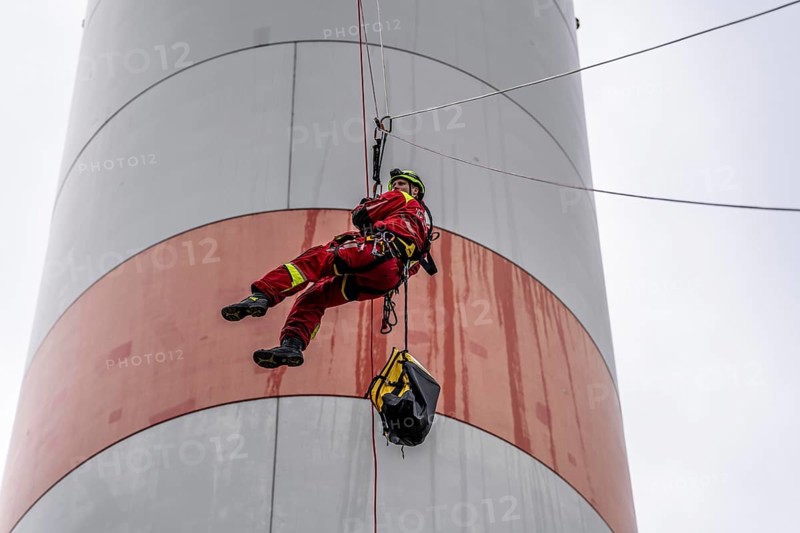 Height rescuers from the Oberhausen fire brigade practise abseiling from a wind turbine from a height of 150 metres after rescuing an accident victim from the nacelle, Issum, North Rhine-Westphalia, Germany, Europe