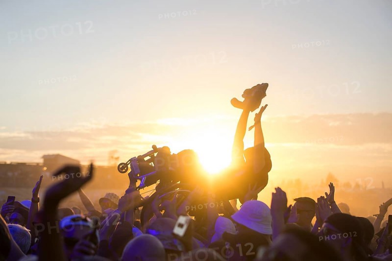 A wheelchair user crowdsurfing in front of sunset at the Highfield Festival on Friday, Störmthaler See, 16/08/2024