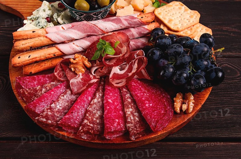 Appetizer, assortment, set, sausage, and cheese, on a wooden board, top view, no people