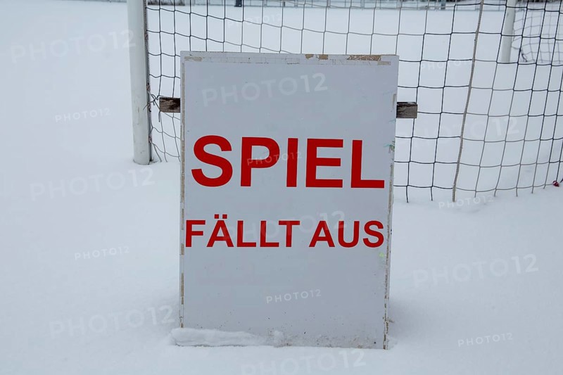Symbolic image of a football match cancelled due to snow. Sign on a sports field with the inscription GAME CANCELLED