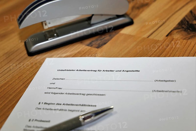 Permanent employment contract for blue-collar and white-collar workers on one desk