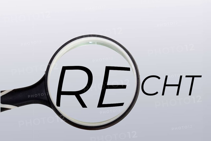 Symbolic image for law, jurisdiction and justice: a magnifying glass over the written word law
