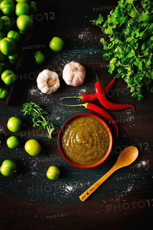 Tkemali sauce, traditional Georgian cuisine, green cherry plum, with ingredients for sauce, cilantro, mint, hot pepper, garlic, on a wooden table, close-up, rustic, food background, no people, selective focus, sauce, green sauce, tkemali, georgian cuisine, homemade